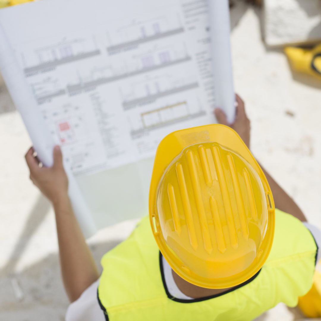 Builder assessing plans